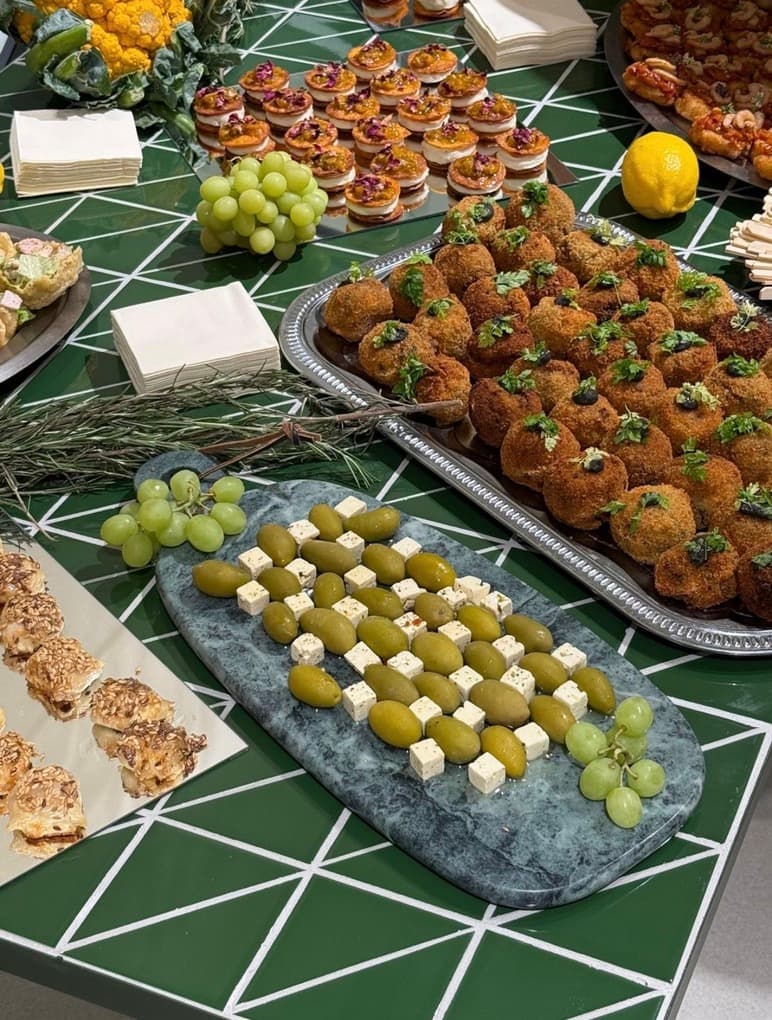 Buffet mezze, olives, féta, bouchées et raisins sur une table verte